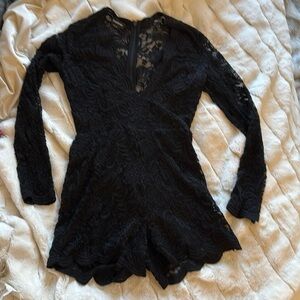 Bebe stretch lace romper with back hidden zipper.